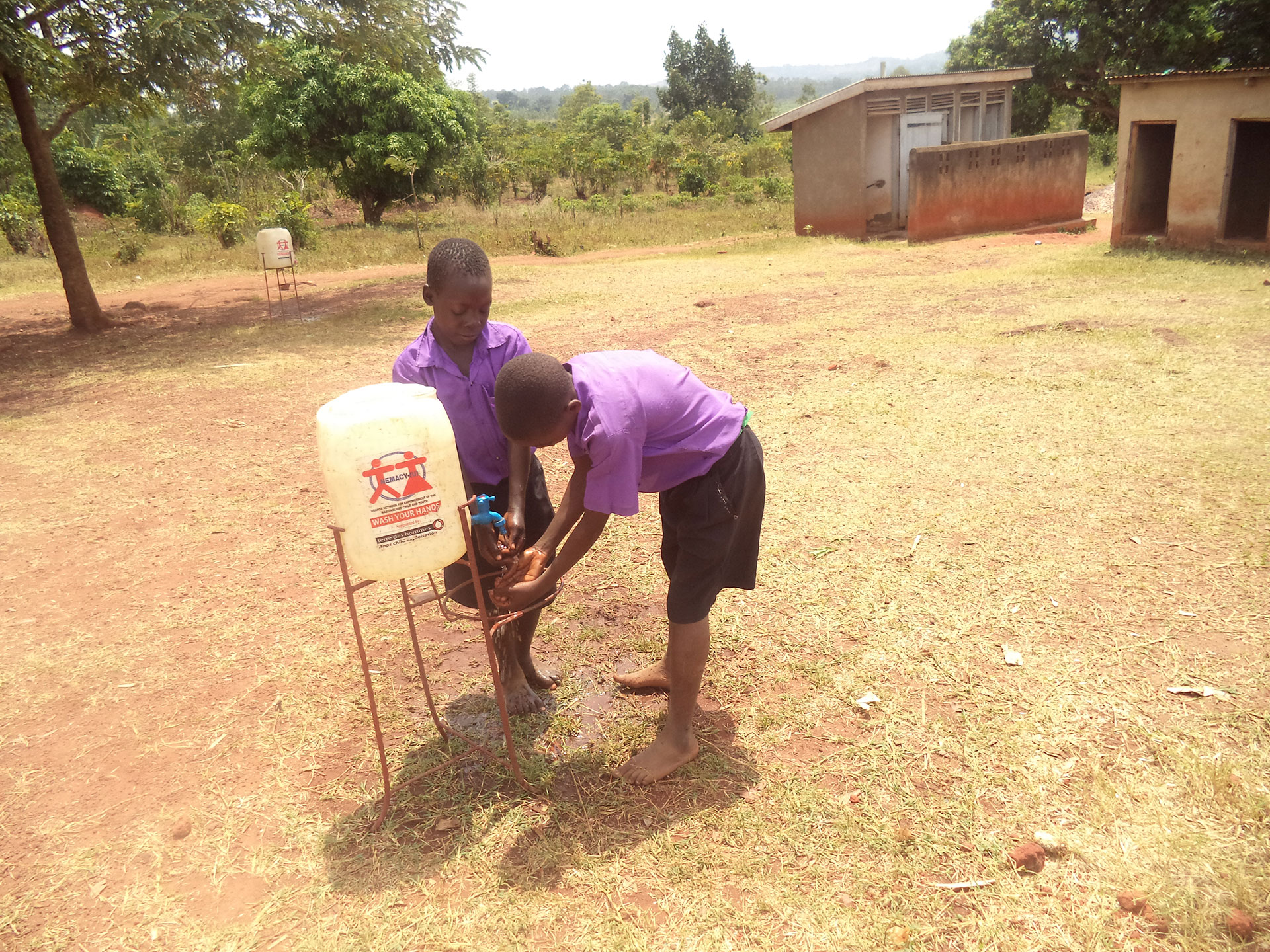 Children at Kiwagama PS Using a Hand Washing Facility provided by NEMACY-UGANDA